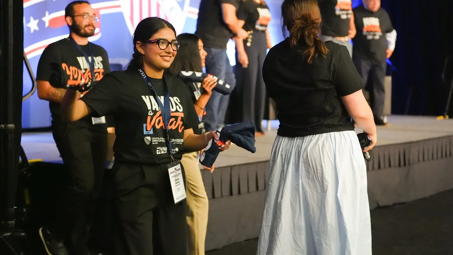 LULAC volunteers distributing Vamos a Votar shirts